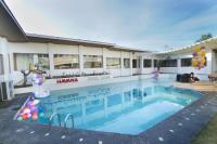 a large swimming pool in front of a building at One Bedroom Private Villa Kuta in Seminyak