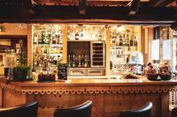 a bar with a lot of bottles of alcohol at Auberge du Manoir in Chamonix