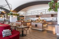 a restaurant with tables and a kitchen in the background at Barceló Playa Blanca in Playa Blanca