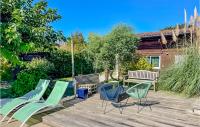 a patio with chairs and a table and a bench at Beautiful Home In Angresse With Wi-fi in Angresse