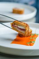 a piece of food on a plate with sauce at Villa Aragonese Rooms in Monte di Procida