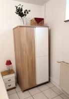 a cabinet with a vase on top of it in a room at Les Gîtes d&#39;Angres - gîte n°1 in Angres