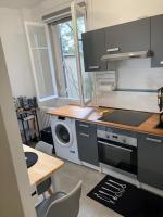 a kitchen with a stove and a microwave and a table at Superb Air-conditioned studio Paris expositions porte de Versailles - Dôme de Paris - JO Olympic Games 2024 Paris Arena Sud 1-4-6 in Vanves