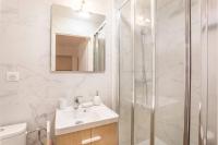 a white bathroom with a sink and a shower at Le nid de la Corderie in Marseille