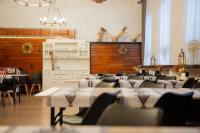 a restaurant with tables and chairs in a room at WRZOS resort & wellness in Węgierska Górka