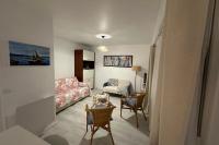 a living room with a couch and a chair at Studio with balcony - 2 min beach and AquaBaule in La Baule