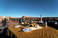 a table with food on top of a balcony at Chez Brahim vue panoramique in Aït Ben Haddou