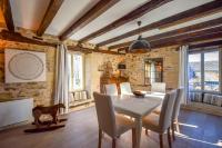 a dining room with a white table and chairs at Domaine d&#39;Essendiéras in Saint-Médard-dʼExcideuil