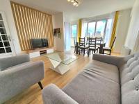 a living room with a couch and a table at Charmant appartement proche Paris in Épinay-sur-Seine