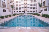 a swimming pool in front of a building at Luxury apartment fully furnished in Casablanca