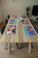 a wooden table with four pictures on it at Disneyland Paris, appartement 70m², parking privé in Serris