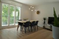 a dining room with a table and chairs at Disneyland Paris, appartement 70m², parking privé in Serris