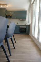 a kitchen with green cabinets and a table and chairs at Disneyland Paris, appartement 70m², parking privé in Serris