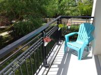a blue chair sitting on a balcony with plants at Disneyland Paris, appartement 70m², parking privé in Serris