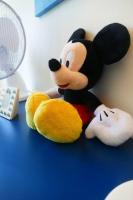 a stuffed toy of mickey mouse sitting on a table at Disneyland Paris, appartement 70m², parking privé in Serris