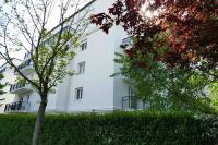 a white building with trees in front of it at Disneyland Paris, appartement 70m², parking privé in Serris