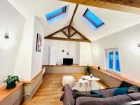 an attic living room with skylights and a couch at Tropical Duplex in Senlis in Senlis