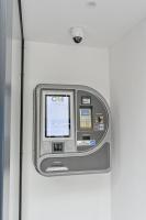 an atm machine with a screen on a wall at City Rooms Wels - contactless check-in in Wels
