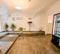 an empty room with a drink cooler and potted plants at City Rooms Wels - contactless check-in in Wels