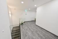 an empty room with a staircase and a white wall at City Rooms Wels - contactless check-in in Wels