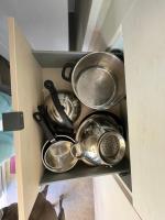 a group of pots and pans in a drawer at Au petit paradis in Camiers