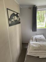 a small bedroom with a bed and a window at Au petit paradis in Camiers