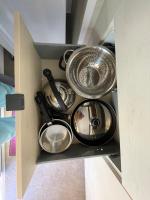 a bunch of pots and pans in a drawer at Au petit paradis in Camiers