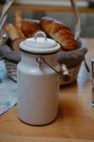 a jar of bread on a table with a basket of bread at Tofererhof in Bad Hofgastein
