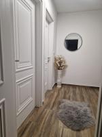 a hallway with a white door and a furry rug at Stan na dan Jelica Stanivuković in Šid