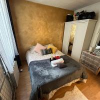 a small bedroom with two beds and a mirror at Private room in Paris