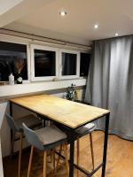 a table and chairs in a kitchen with windows at Studio cosy in Brussels