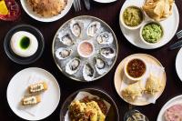 Una mesa llena de platos de comida con ostras encima. en Grand Hyatt Melbourne, en Melbourne