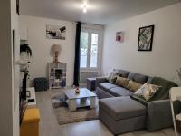 a living room with a couch and a coffee table at Cocooning House 204 Suite Green- Superb studio Aéroport PARIS Roissy CDG, Parc ASTERIX, Château de CHANTILLY, STADE DE FRANCE in Survilliers