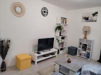 a white living room with a flat screen tv at Cocooning House 204 Suite Green- Superb studio Aéroport PARIS Roissy CDG, Parc ASTERIX, Château de CHANTILLY, STADE DE FRANCE in Survilliers