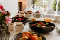 a table topped with bowls of food and fruit at Hotel Vier Jahreszeiten Starnberg in Starnberg