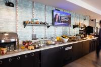 a kitchen with a counter with food on it at Campanile Limoges Centre - Gare in Limoges