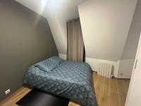 a small bedroom with a bed in a room at Parisian Skyline Oasis: Panoramic Elegance, Luxury at Your Doorstep in Saint-Ouen