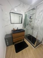 a bathroom with a sink and a shower at Parisian Skyline Oasis: Panoramic Elegance, Luxury at Your Doorstep in Saint-Ouen