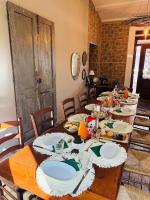 a long wooden table with white plates on it at Agriturismo La Mia Terra in Mesa