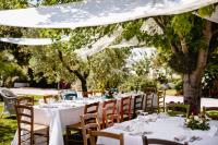 a table set up for a wedding reception under a white tent at Agriturismo La Mia Terra in Mesa