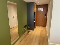 a hallway with a green wall and a wooden door at Hôtel Exsel Créolia in Saint-Denis