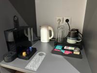 a counter with a coffee maker and other items on it at Hôtel Exsel Créolia in Saint-Denis