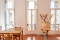 a room with a table and chairs and windows at |Aaa|- Pure &amp; Natural Massilia City Center in Marseille