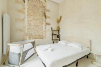 a small bedroom with a bed and a brick wall at |Aaa|- Pure &amp; Natural Massilia City Center in Marseille