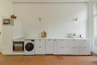 a white kitchen with a stove and a washing machine at |Aaa|- Pure &amp; Natural Massilia City Center in Marseille