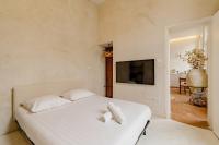 a bedroom with a white bed with two pillows on it at |Aaa|- Pure &amp; Natural Massilia City Center in Marseille