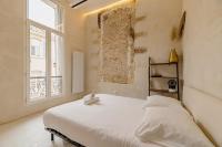 a bedroom with a white bed and a window at |Aaa|- Pure &amp; Natural Massilia City Center in Marseille
