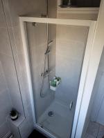 a shower with a glass door in a bathroom at La Compiègnoise - Spacieux - Lumineux - Cosy in Compiègne