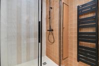 a shower with a glass door in a bathroom at CMG - La Butte Montmartre in Paris