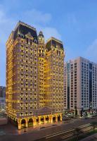 a large building with lights on in a city at Royal Rose Abu Dhabi, a Curio Collection by Hilton Affiliated Hotel in Abu Dhabi